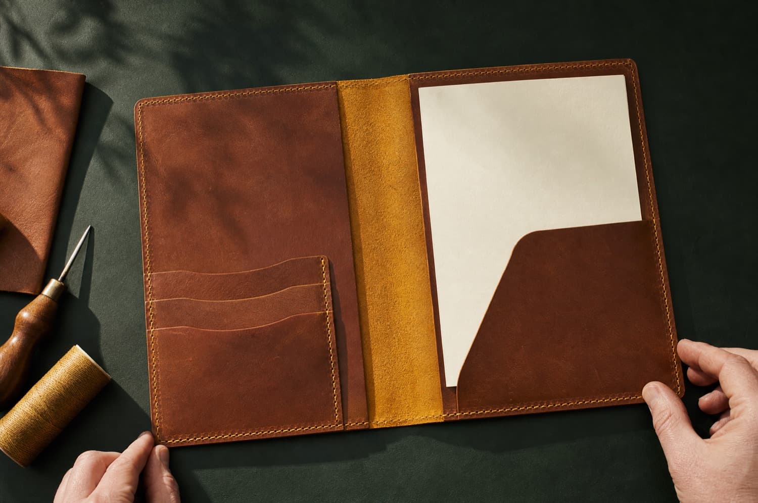 Folio A5 photographed closed on a deep green ground