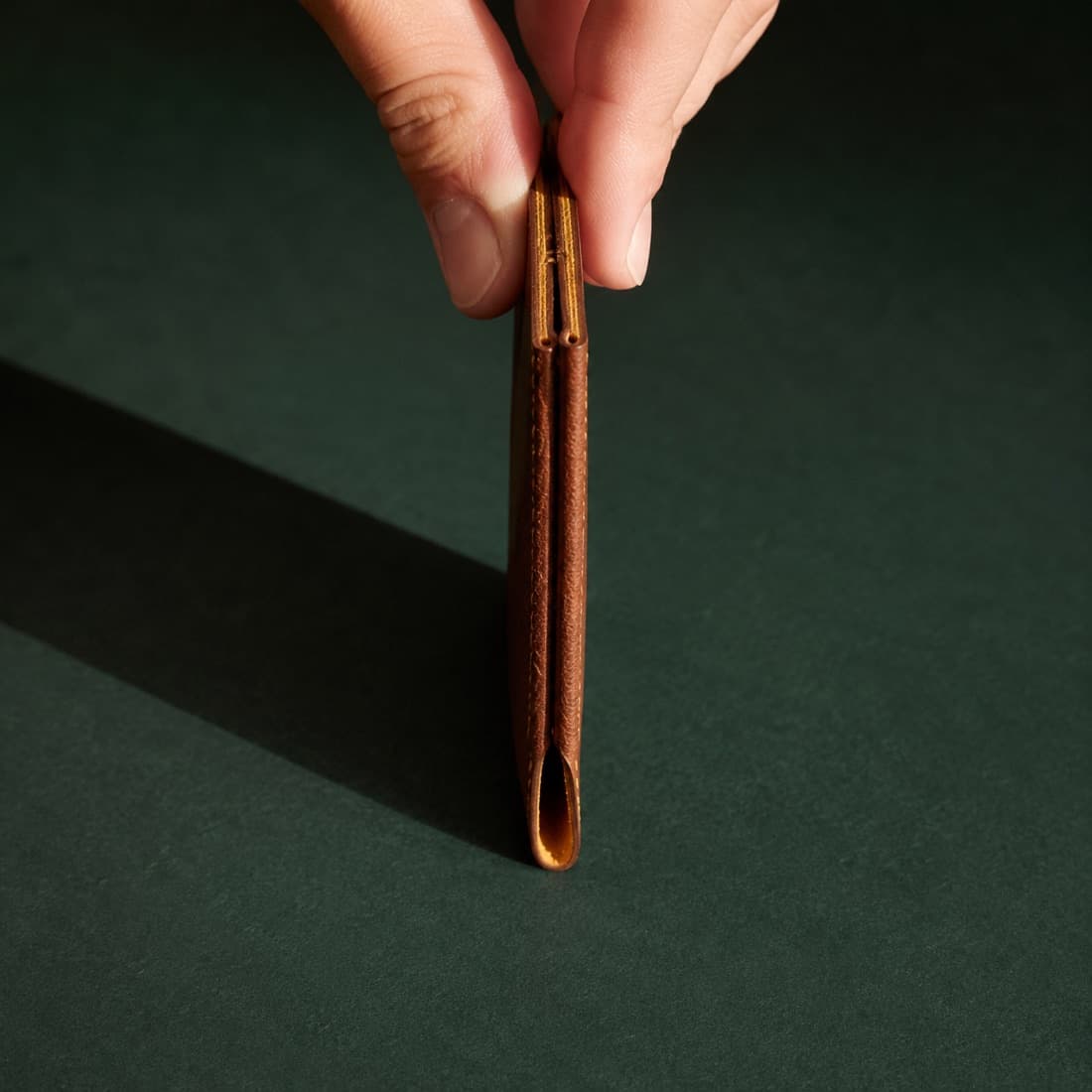 Cover Single Slim photographed closed on a deep green ground