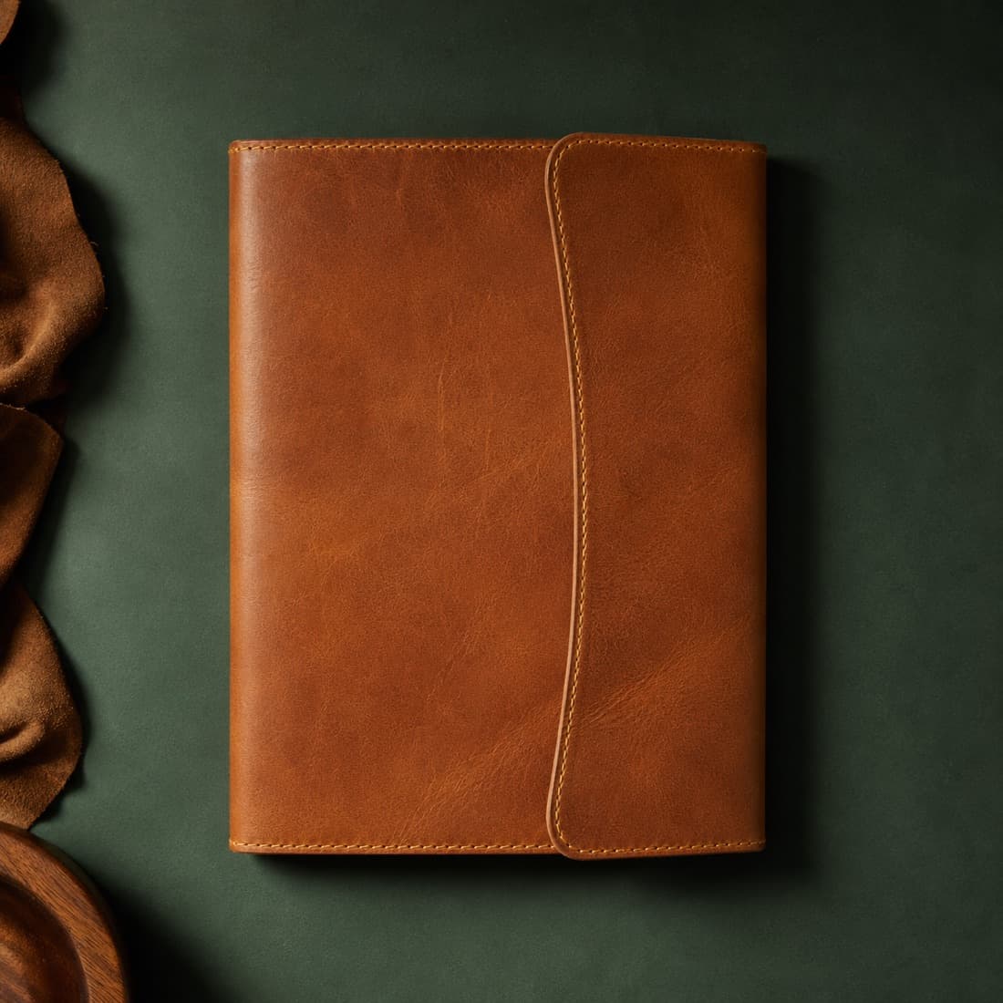 Folio Full-Grain photographed closed on a deep green ground